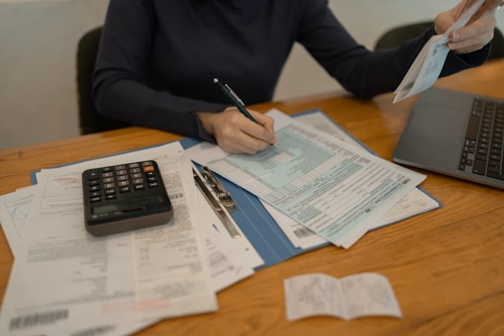 Tax form with a pen and calculator in an office setting