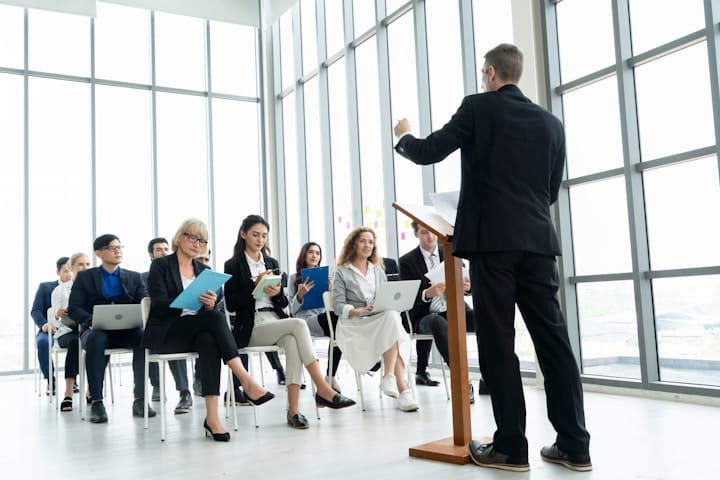 A confident leader addressing a team meeting, showcasing their presence and authority