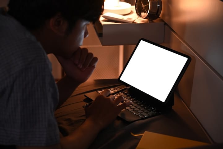 Person typing on a laptop while brainstorming content ideas