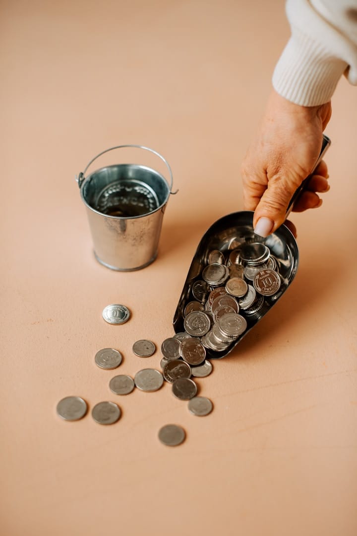 Hands Counting Coins to Represent Cost Cutting