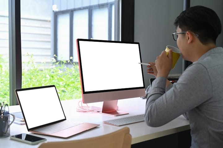 People Reviewing a Business on a Laptop