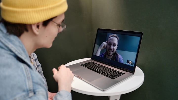 A person engaging in a virtual meeting using video conferencing tools