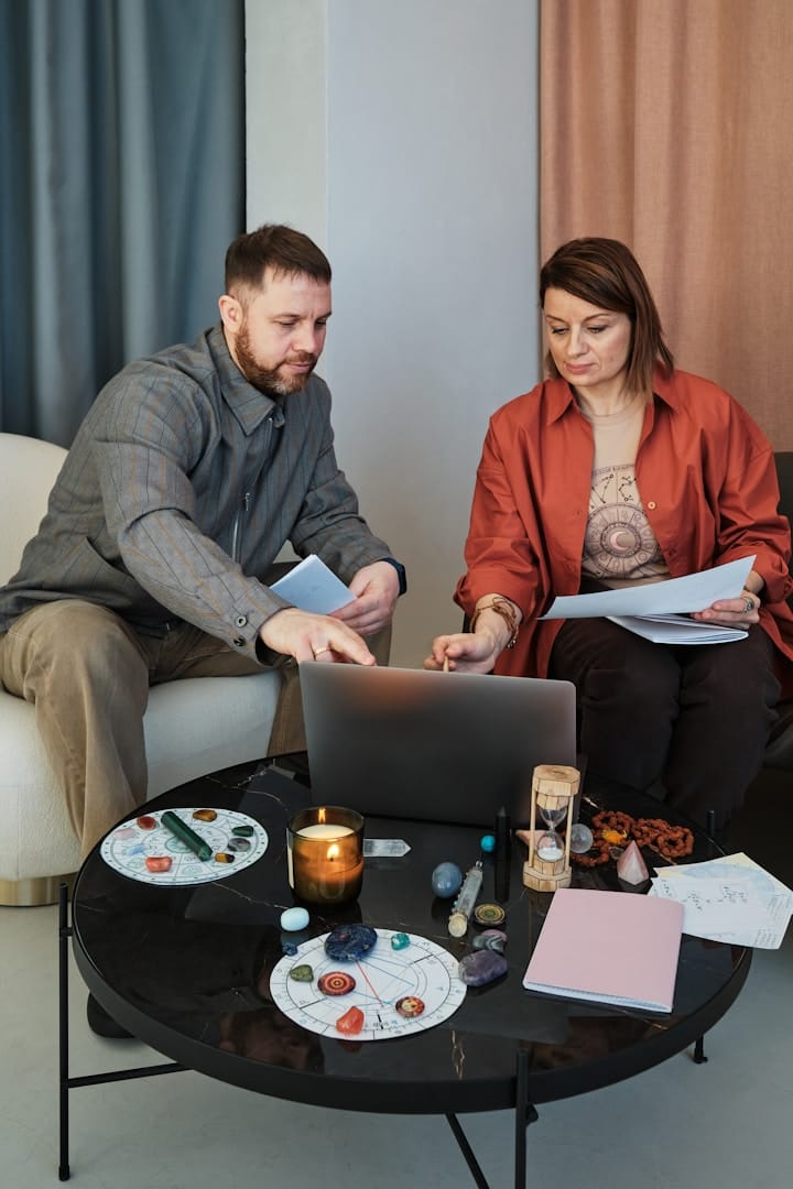 Couple with a real estate agent discussing investment plans at a desk