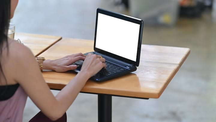 Person designing a website on a laptop