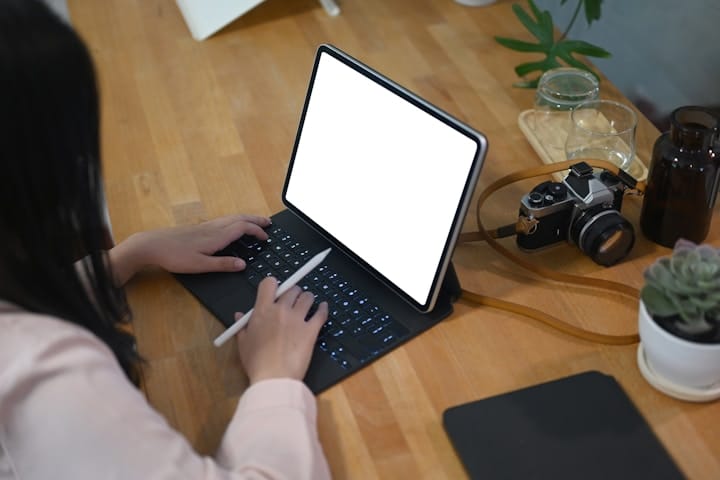 Person Typing on a Laptop with Creative Ideas